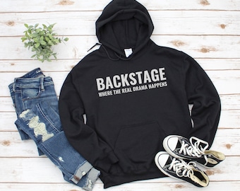 May include: Black hooded sweatshirt with the text "Backstage Where the Real Drama Happens" in white lettering.