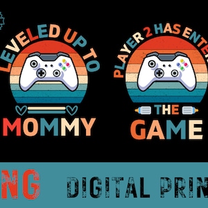 May include: A digital print design with a retro-style video game controller and the text "Leveled Up To Mommy" and "Player 2 Has Entered The Game".