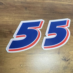 May include: A blue and red number 55 sticker. The number is outlined in red and white.