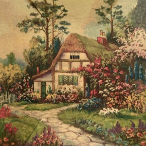 May include: A quaint cottage with a thatched roof sits nestled in a lush garden. The cottage is painted white with green shutters and a small green door. The garden is filled with colorful flowers in shades of pink, purple, red, and yellow. A stone path leads to the front door of the cottage.