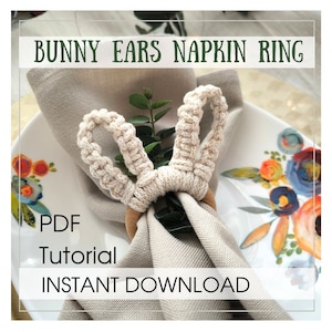 May include: A macrame bunny ears napkin ring in beige sits on a folded linen napkin. The napkin ring is made of woven cord and has a wooden ring base. The image includes the text "BUNNY EARS NAPKIN RING" at the top, with "PDF Tutorial INSTANT DOWNLOAD" below.