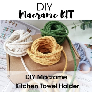 May include: DIY Macrame Kitchen Towel Holder kit with three spools of cord in natural, yellow, and green colors. The kit includes instructions and wooden rings.