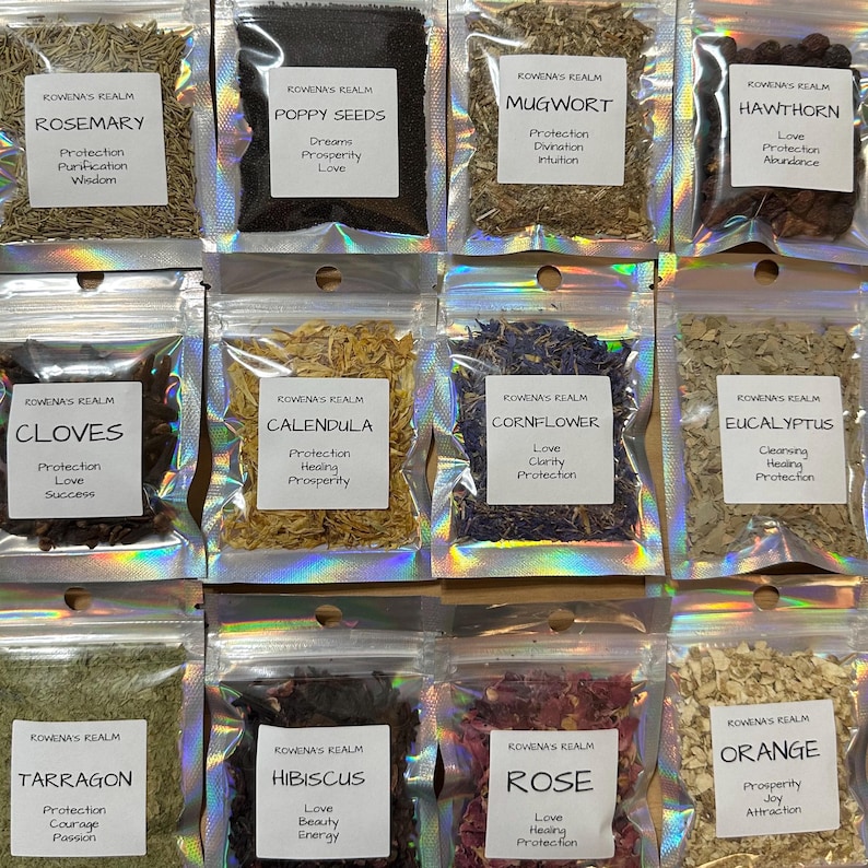 May include: Assortment of dried herbs and seeds in clear, sealed pouches. Each pouch has a white label with the herb's name and associated properties. Herbs include rosemary, poppy seeds, mugwort, hawthorn, cloves, calendula, cornflower, eucalyptus, tarragon, hibiscus, rose, and orange.