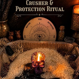 May include: A purple glittery skull-shaped candle with a lit flame sits in a metal tray filled with white rice. Behind it is a circular board with the text Stagnation Crusher & Protection Ritual, featuring an eye illustration and the words Yes, No, Maybe, and Rephrase.