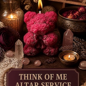 May include: A dark pink bear-shaped candle with a lit wick, surrounded by clear quartz crystals, small round pink stones, and a small bowl with a lit tea light. A dark rectangular sign displays the text: THINK OF ME ALTAR SERVICE HEALING OBSESSION SHIELD.