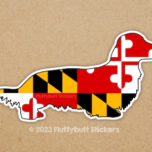 May include: A dachshund silhouette sticker with the Maryland state flag colors and design. The sticker features the words "Fluffybutt Stickers" and "© 2023 Fluffybutt Stickers".