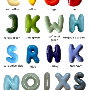 May include: A selection of brightly coloured, bubble-style letters in shades like yellow, orange, red, green, and blue. Each letter is labelled with its colour name, such as "soft yellow" and "turquoise blue".