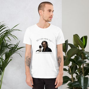 May include: White t-shirt with a black and white image of a person speaking into a microphone. The text "YES, I CAN HEAR YOU" is above the image and "CLEM FANDANGO" is below the image.