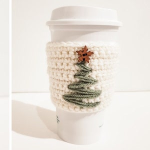 Two vertical side by side images of a crocheted Christmas Tree coffee cozy. The left is a close up image of the right displayed on a white Starbucks mug. The cozy is minimalist using green and cream yarn and a wooded button.