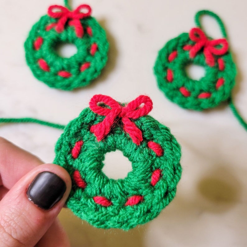 The crochet mini Christmas wreath cozy.