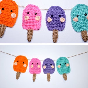 May include: A garland of crocheted popsicles in orange, pink, purple, and teal. Each popsicle has a smiling face with black eyes and pink cheeks.