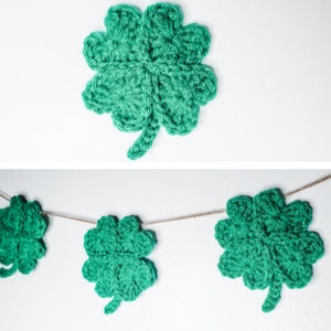 May include: A green crocheted four-leaf clover garland with three clovers hanging on a string.