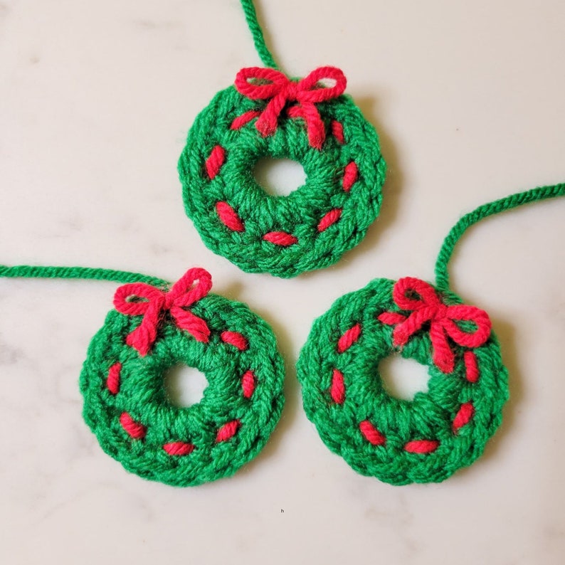 The crochet mini Christmas wreath cozy.