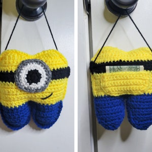 Front and back images of the Crochet Tooth Fairy Pillow - Yellow guy hanging on a door knob.