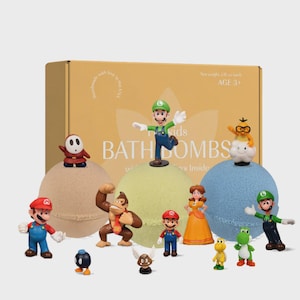 May include: A gift set of children's bath bombs with character figurines. The set includes a yellow box with the words "kids BATH BOMBS" and "handmade with love in the USA". The bath bombs are in various colours, and the figurines are of popular characters.