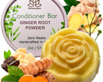 May include: A yellow conditioner bar shaped like a rose with a label that reads "Relaxcation Conditioner Bar Ginger Root Powder Zero Waste Handcrafted in [unclear] 2oz / 57g". The bar is surrounded by ginger root, turmeric root, and green leaves.