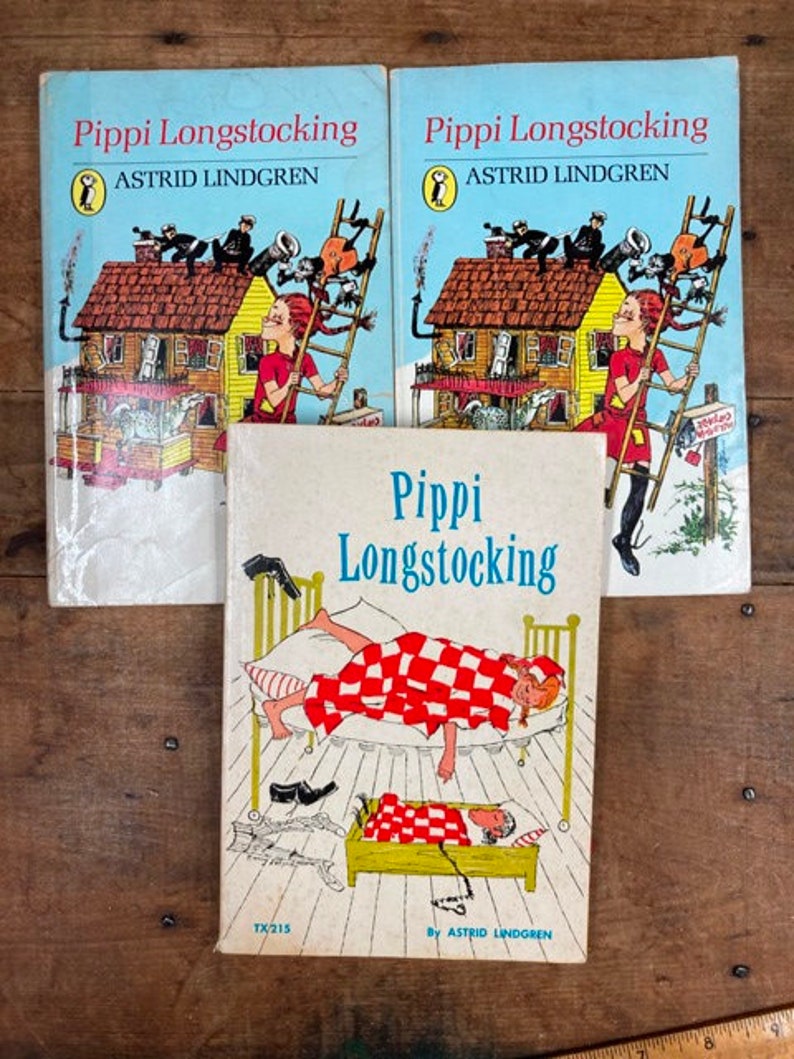May include: Three vintage hardcover books with colorful illustrations of Pippi Longstocking, a fictional character created by Astrid Lindgren. The books are titled "Pippi Longstocking" and feature the text "Astrid Lindgren" on the cover.