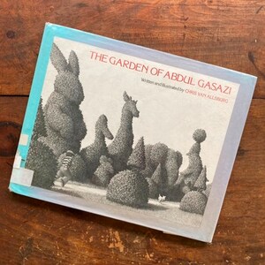 May include: A book titled "The Garden of Abdul Gasazi" written and illustrated by Chris Van Allsburg. The cover features a black and white illustration of a garden with topiary animals.