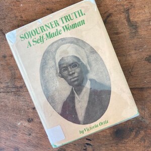 May include: A vintage book titled "Sojourner Truth, A Self-Made Woman" by Victoria Ortiz. The cover features a black and white portrait of Sojourner Truth.