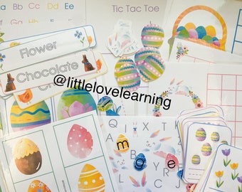 May include: A set of Easter-themed educational materials for children. The set includes alphabet cards, a tic-tac-toe board, a flower and chocolate word card, and a variety of Easter egg-themed activities.
