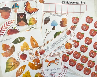 May include: A set of educational activity cards and stickers featuring autumn themes. The cards include images of leaves, acorns, mushrooms, and a fox. The stickers feature letters of the alphabet and numbers. The cards have titles such as "Nature Hunt", "Mushroom", and "Run Quick Like a Fox".
