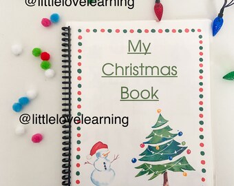May include: A white book with a red and green polka dot border. The title is "My Christmas Book" with a snowman and a Christmas tree illustration. The book has a spiral binding.