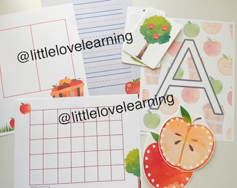 May include: A set of printable educational materials for children featuring an apple theme. The set includes a worksheet with a grid, lined paper, a blank page with a basket of apples, a page with an apple tree, and a page with the letter A and a repeated pattern of apples. The text "@littlelovelearning" is visible on the pages.