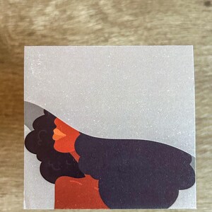 Puede incluir: Una ilustración digital de una mujer con cabello oscuro y piel roja que lleva un sombrero blanco. La mujer está mirando hacia la derecha de la imagen.