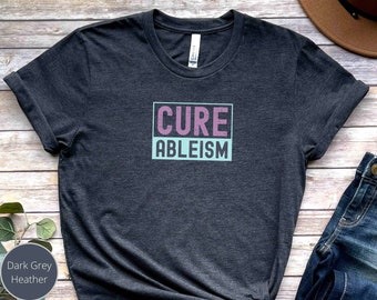 May include: Dark grey heather t-shirt with the text "Cure Ableism" in a pink and blue box.