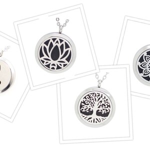 May include: Four silver pendant necklaces with various designs. One features a Yin Yang symbol, another a lotus flower, a third a floral pattern, and the last a tree of life. Each pendant hangs from a delicate chain.