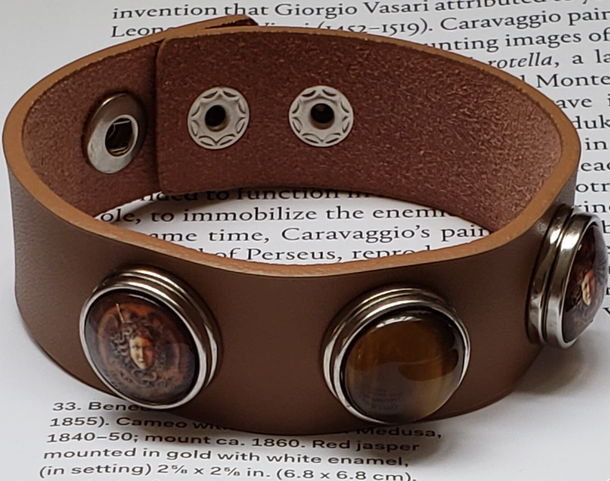 Snap bracelet. Brown leather snap cuff bracelet with three snap charms