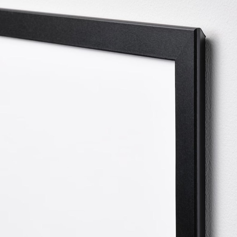 May include: A black picture frame with a white mat. The frame is made of wood and has a simple, modern design.