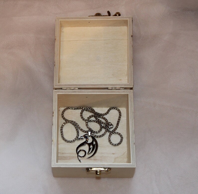 Small wooden trinket box with a pyrographed dragon design