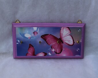 Pink butterfly decoupage key rack on a blue background