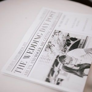 Puede incluir: Un peri&oacute;dico en blanco y negro titulado "THE WEDDING DAY POST" con la fecha "S&Aacute;BADO 18 DE SEPTIEMBRE DE 2021". El titular dice "ARLYN AND ROGER ARE GETTING MARRIED". La imagen muestra a una pareja bes&aacute;ndose.