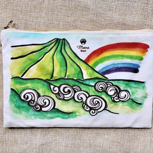 May include: A white canvas zippered pouch with a watercolour illustration of a green mountain with a rainbow over it. The text "Mana Hawaii" is printed in black on the pouch.