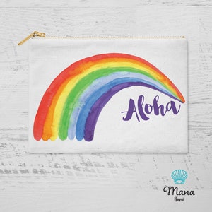 May include: A white canvas zippered pouch with a rainbow watercolour design and the word "Aloha" in purple script.