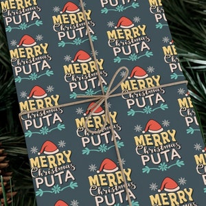 May include: A dark blue wrapping paper with a repeating pattern of red Santa hats and the text "Merry Christmas Puta" in yellow and teal.