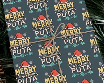 May include: A rectangular gift box wrapped in dark blue paper featuring a repeating pattern of the text Merry Christmas PUTA in yellow and white, accented with red Santa hats and teal flourishes, tied with thin brown twine.