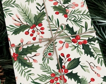 May include: A white gift wrap with a repeating pattern of green holly leaves and red berries. The paper is tied with twine.