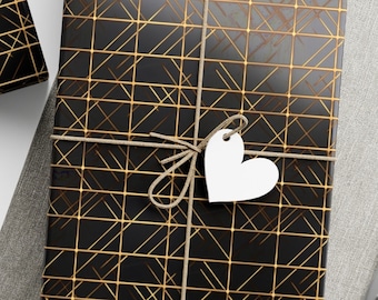 May include: Three black gift boxes with gold geometric patterns wrapped with twine and white paper tags. The boxes are on a light gray surface.