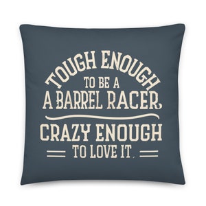 Könnte beinhalten: Ein dunkelblaues Kissen mit weißem Text, der "Tough Enough to be a Barrel Racer Crazy Enough to Love It." lautet.