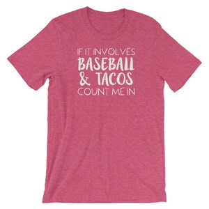 May include: Pink t-shirt with white text that reads "If it involves baseball & tacos count me in."