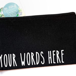May include: Black canvas zippered pouch with white text that reads "YOUR WORDS HERE".