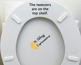 The tweezers are on the top shelf funny insulting vulgar toilet seat bathroom sticker decor decoration