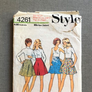 May include: Vintage sewing pattern for a skirt, size 9/10, waist 61 cm. The pattern shows four different styles of skirts, including a yellow and white patterned skirt, a red skirt, a blue skirt, and a floral print skirt. The pattern is labelled "Style 4261" and includes instructions for making the skirts.