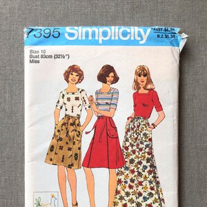 May include: Vintage Simplicity sewing pattern envelope, size 10, bust 83cm. The illustration shows three women in various outfits, including skirts and tops. The envelope is blue and white with text and a bird graphic.