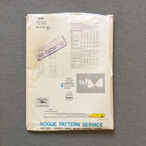 May include: A vintage Vogue sewing pattern for a dress, with a size 12 bust measurement of 34 inches. The pattern is for a long or short dress and is made for knit fabrics. The pattern is labeled "1548" and has a stamp that says "No Exchange".
