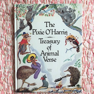 May include: The cover of a children's book titled "The Pixie O'Harris Treasury of Animal Verse" published by Golden Press. The cover features illustrations of various Australian animals, including a koala, a kookaburra, an echidna, and a cassowary.