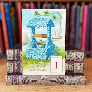 Happy New Year Postcard with blue forget me not wishing well, four leaf clover for good luck, white dove for peace, vintage January 1st card
